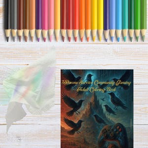May include: A selection of coloured pencils in a range of hues, positioned above a colouring book titled "7 Ravens Survive Community Gaming Adult Coloring Book." The book shows raven illustrations and a game controller.