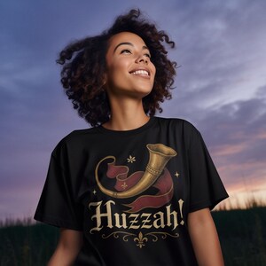 Funny Huzzah renaissance fair t-shirt for cosplay and festival fans at sunset.