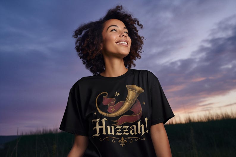 Funny Huzzah renaissance fair t-shirt for cosplay and festival fans at sunset.