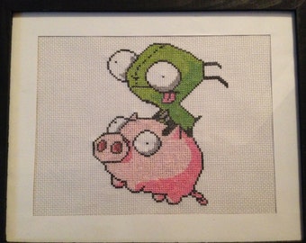 Gir riding a rubber piggy - framed cross stitch