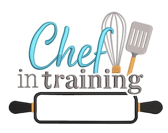May include: A white background features the text "Chef in training" in blue and gray. A whisk, spatula, and rolling pin are also included in the design. The rolling pin has black handles and a rectangular space in the middle.