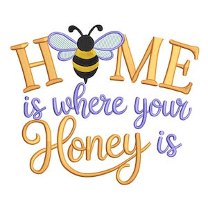 May include: A whimsical design featuring the phrase "HOME is where your Honey is" in gold and purple script. A cartoon bee with black and yellow stripes and blue wings is centered above the word "HOME". The design is on a white background.