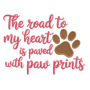 May include: A white background with the phrase "The road to my heart is paved with paw prints" in pink script. A brown paw print graphic is to the right of the text.