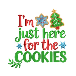 May include: A Christmas-themed design with the text "I'm just here for the cookies" in red and green. The design includes a star-shaped cookie, a Christmas tree cookie, and star accents.