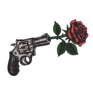 May include: An embroidered patch featuring a silver and black revolver with a red rose and green leaves emerging from the barrel. The design uses detailed stitching to create shading and texture on the firearm and the floral elements.