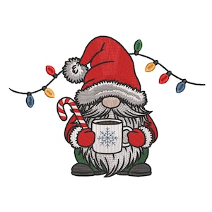 May include: Embroidered Christmas gnome wearing a red hat and holding a candy cane and a mug with a snowflake design. The gnome is surrounded by a string of colorful Christmas lights. The gnome has a long white beard and is wearing red gloves.