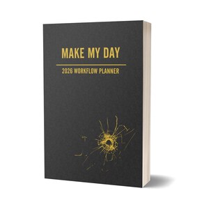 May include: A black 2026 workflow planner with the words "MAKE MY DAY" in gold lettering. The planner has a gold abstract design on the front cover.