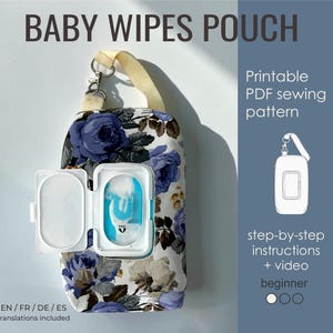 May include: A baby wipes pouch with a floral pattern in shades of blue, grey, and white. It features a white plastic flip-top opening, a beige fabric strap with a metal clip, and text reading BABY WIPES POUCH, Printable PDF sewing pattern.