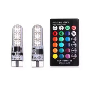 Op de afbeelding: Twee LED-autolampen en een afstandsbediening. De zwarte afstandsbediening heeft knoppen voor kleurselectie, waaronder rood, groen en blauw, en functies zoals stroboscoop en fade. De tekst luidt "MULTI COLOR LED SYSTEM CAR".