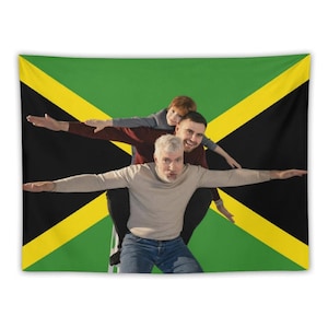 May include: A tapestry featuring the Jamaican flag as a backdrop. Three people are positioned in front of the flag with their arms outstretched. The tapestry has a green background with black and yellow diagonal stripes.