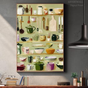 May include: A framed print depicting a variety of kitchenware. The artwork showcases teapots, bowls, spoons, and cutting boards, arranged on shelves against a light green backdrop. The style is reminiscent of a still life painting, with a focus on kitchen essentials.