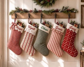 May include: Five Christmas stockings hanging on a wooden rack. The stockings feature various patterns including red gingham, striped, and reindeer prints, with white cuffs embroidered with the names Harper, Wyatt, Ethan, Grace, and Lucy.