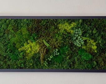 May include: Rectangular framed wall art featuring a vibrant display of preserved moss and plants. The artwork showcases a variety of green hues, from deep forest to bright lime, creating a natural, textured appearance. The dark frame provides a clean border.
