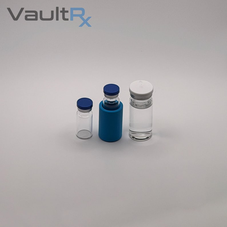 May include: Three clear glass vials with blue and white caps. One vial is in a blue holder. The vials are of varying sizes and are empty. The text "VaultRx" is in the upper left corner.
