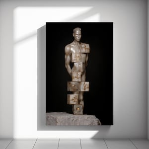 May include: A sculpture of a male figure with a smooth, light-colored finish. The figure is partially obscured by a series of stacked, square blocks with gold-colored accents. The sculpture rests on a stone base against a black backdrop.
