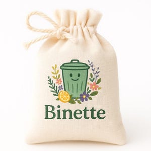 May include: A drawstring bag made of natural-colored fabric. The bag features a green smiling trash can illustration surrounded by flowers and a lemon slice. The word "Binette" is printed in green below the illustration.