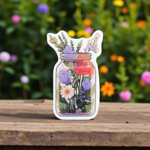A bouquet of purple pink white flower in mason jar sticker