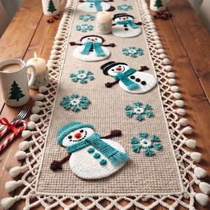 May include: A beige crocheted table runner featuring white snowmen with teal scarves and hats, accented by teal snowflake motifs. The runner has a decorative lattice border with white tassels along the edges, creating a textured winter design.