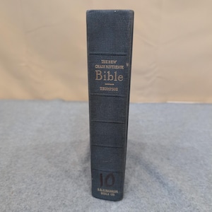 May include: A dark teal-colored book with gold lettering. The spine reads "THE NEW CHAIN REFERENCE Bible" and "THOMPSON." The number "10" is visible at the bottom, along with the text "B.B. KIRKBRIDE BIBLE CO."