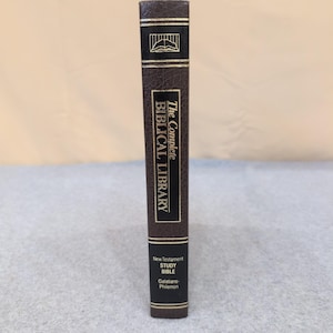 May include: A brown hardcover book titled "The Complete Biblical Library." The spine features gold lettering and a gold emblem. The book is a New Testament Study Bible, covering Galatians-Philemon.