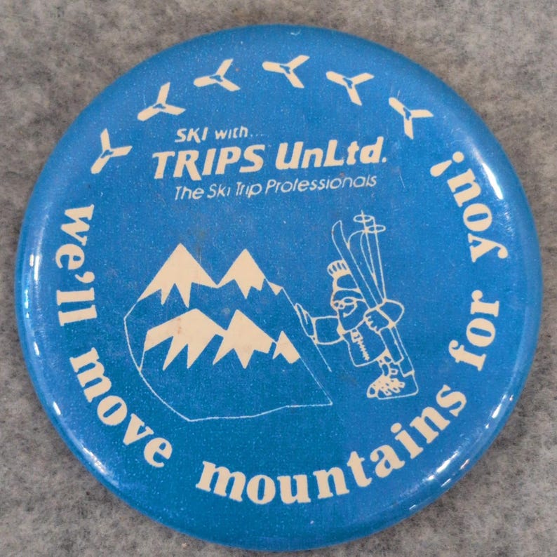 Trips Unltd. Ski The Ski Trip Professionals Vtg Button Pin We'll Move Mountains image 1