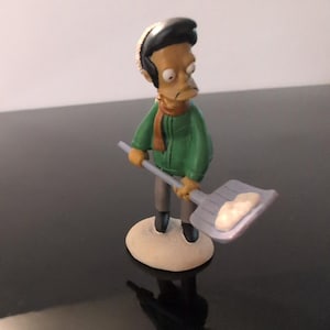 The Simpsons Apu Christmas Figurine Santa Hat Snow Shovel Winter Collectible image 1