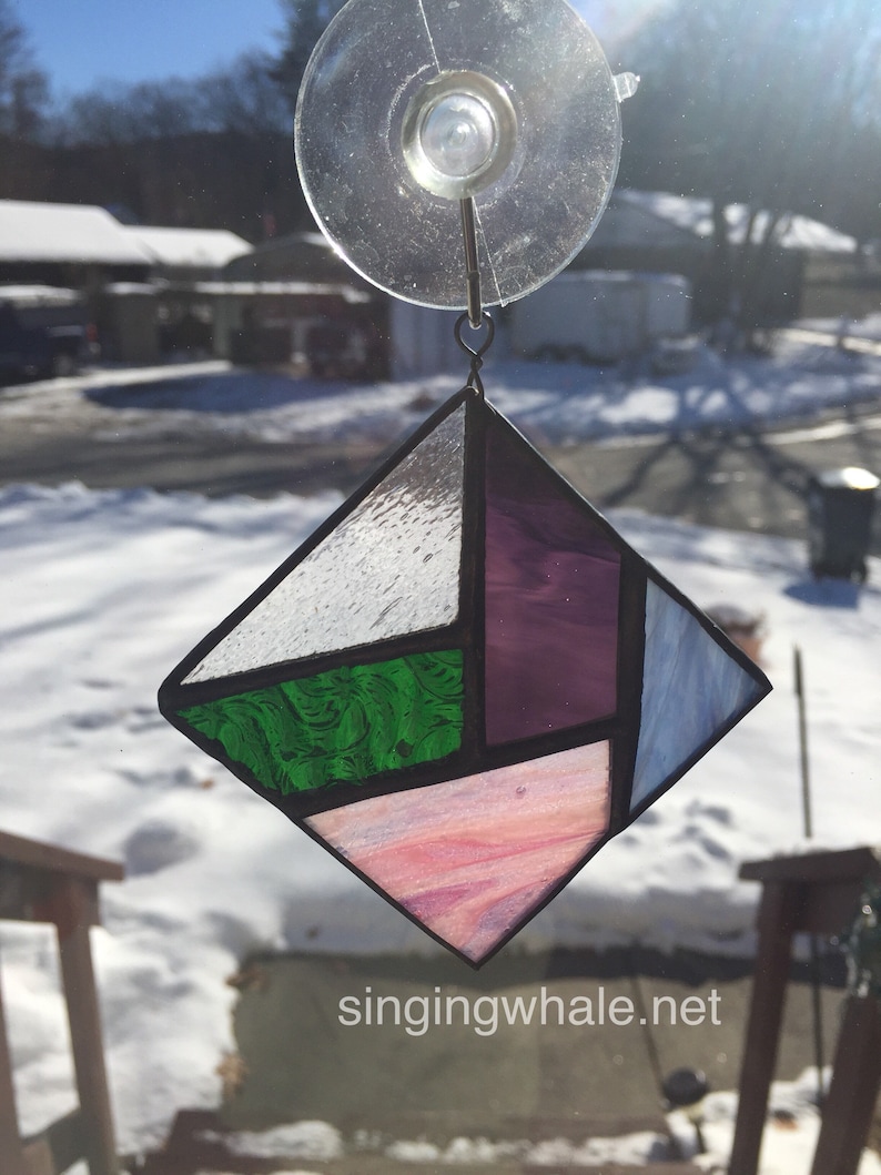 Stained glass geometric ornament clear purple green pink blue