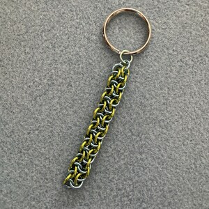May include: A gold and silver chain keyring with a silver ring.
