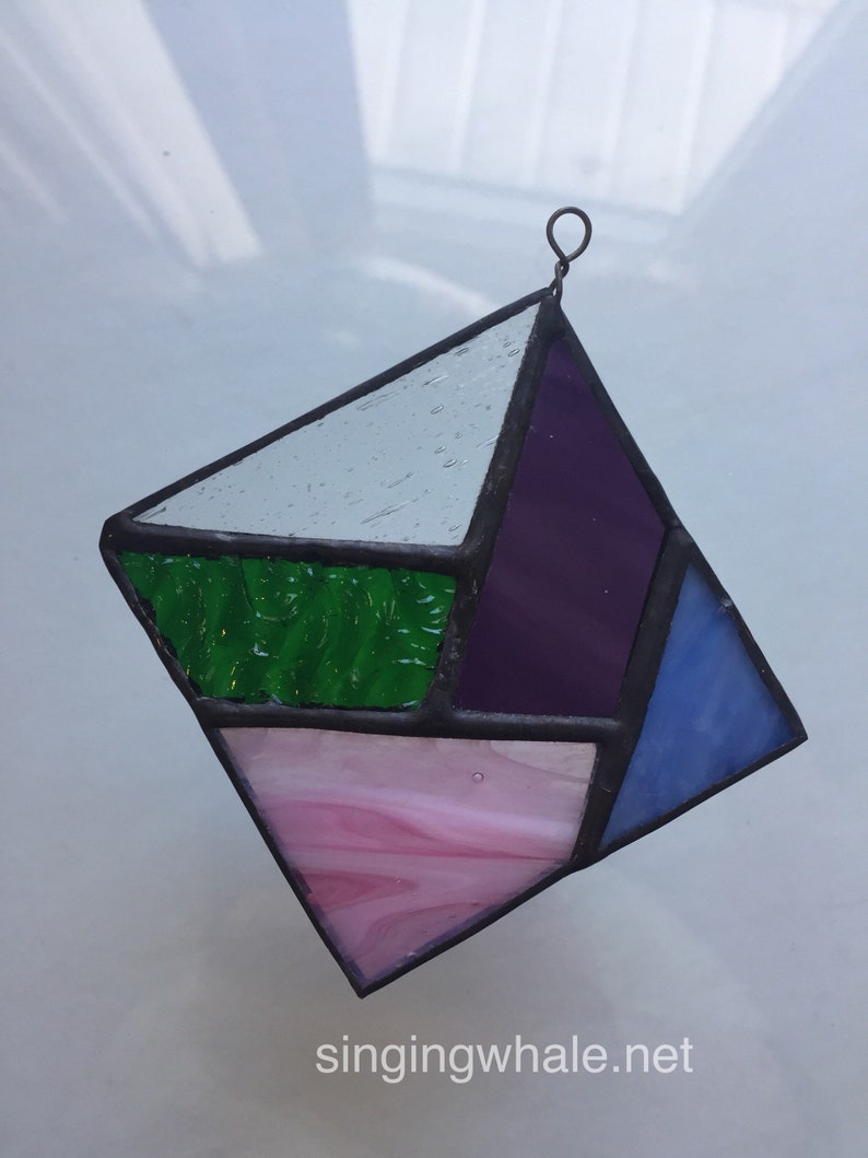 Stained glass geometric ornament clear purple green pink blue