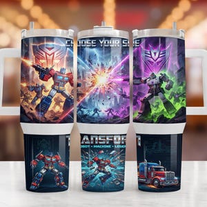 May include: A cylindrical tumbler with a handle featuring Transformers graphics. The design displays Optimus Prime and Megatron in battle, the text CHOOSE YOUR SIDE and TRANSFORMERS, and a red truck. The tumbler has a white lid and base.