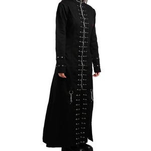 May include: A long black coat with a high collar and long sleeves. The coat is adorned with silver-coloured safety pins down the front and sides. Silver metal rings and chains are also visible. The coat is made of a dark, possibly heavy fabric, suitable for cooler weather.