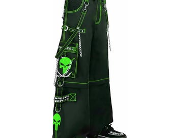 May include: Black cargo pants with neon green stitching and accents. Features include skull graphics, chains, and multiple pockets. The pants have a drawstring waist and are styled with black and white checkered sneakers.