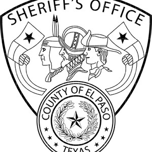 May include: Black and white Sheriff's Office emblem. The emblem features three profile portraits, flags, and the text "SHERIFF'S OFFICE" at the top. The words "COUNTY OF EL PASO" and "TEXAS" are also included.