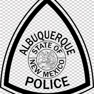May include: Black and white Albuquerque Police badge. The badge is a black triangle with rounded corners, with the words "ALBUQUERQUE" and "POLICE" in a bold font. The center circle reads "STATE OF NEW MEXICO".