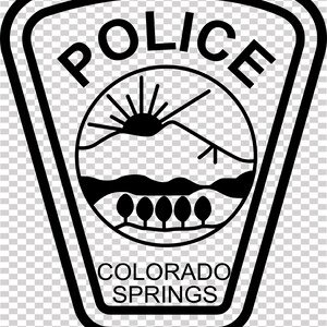 May include: Black and white Colorado Springs Police badge design. The badge features the word "POLICE" at the top, a circular emblem with a mountain and trees, and the words "COLORADO SPRINGS" at the bottom.