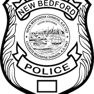 May include: Black and white police badge featuring the words "NEW BEDFORD" at the top. The badge includes a detailed illustration of a harbor scene with ships and buildings, and the word "POLICE" at the bottom.
