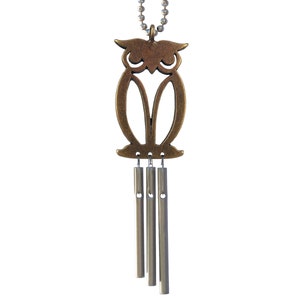 May include: A brass owl wind chime with four silver tubes hanging from the bottom. The owl is a cutout design with a detailed face.