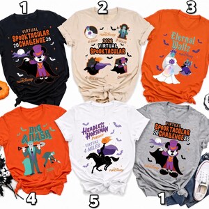 May include: Five short-sleeved t-shirts in black, beige, orange, white, and gray featuring Disney-themed Halloween graphics. Designs include Mickey Mouse as a vampire, the Headless Horseman, and various characters with text like Virtual Spooktacular Challenge 2026, Eternal Waltz, and Dig & Dash.