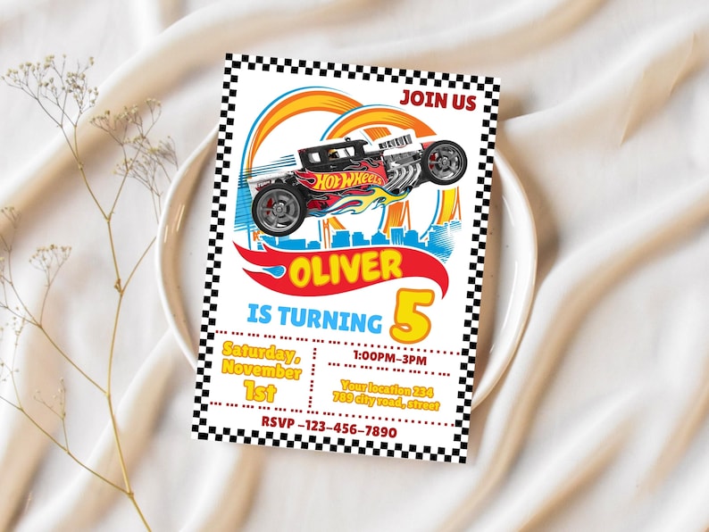 May include: A colorful Hot Wheels-themed birthday invitation. The design features a race car graphic with the text "OLIVER IS TURNING 5". Includes event details: date, time, location, and RSVP information. The invitation has a checkered border.