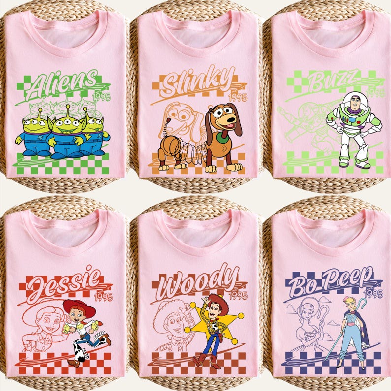 May include: Six pink t-shirts featuring characters from the animated film Toy Story. Each shirt has a different character design, including Aliens, Slinky, Buzz, Jessie, Woody, and Bo Peep, with the year 1995 displayed.