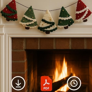 May include: A garland of five crocheted Christmas trees in red, green, and cream colors, adorned with gold beads. The trees are suspended from a dark brown string, creating a festive holiday decoration.