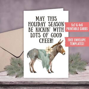 May include: A festive greeting card with a watercolour illustration of a donkey adorned with a teal blanket and a flower. The card displays the text "MAY THIS HOLIDAY SEASON BE KICKIN' WITH LOTS OF GOOD CHEER!" and is available as printable cards.