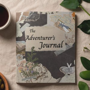 May include: A rectangular journal with a collage-style cover featuring the text The Adventurer's Journal. The design includes layered paper elements, botanical illustrations of flowers and leaves, a butterfly, and a map graphic on a dark background.