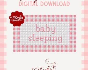 May include: A digital needlepoint chart featuring the text "baby sleeping" in pink letters on a white grid background with a pink gingham border. The design includes a red scalloped logo with the text "Cheeky NEEDLEPOINT" and a bottom logo.