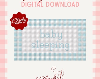 May include: A digital needlepoint chart featuring the text baby sleeping in light blue on a grid pattern with a blue and white gingham border. The design includes a red scalloped logo with the text Cheeky Needlepoint and a signature logo.