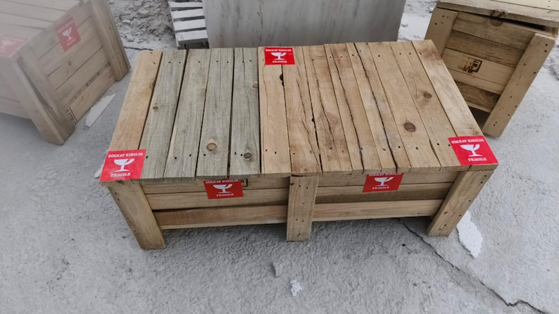 May include: Wooden crates with a rustic appearance. The crates are made of light-colored wood and feature red "Fragile" labels. The design includes visible wood grain and nail heads, suggesting a handmade construction. The crates are suitable for storage or display.