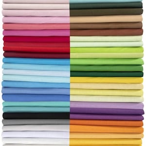 May include: A collection of folded fabric in various colors, including pink, red, blue, green, yellow, and orange. The fabric is neatly stacked, showcasing a range of hues from light pastels to vibrant shades. The image presents a diverse palette of textiles.
