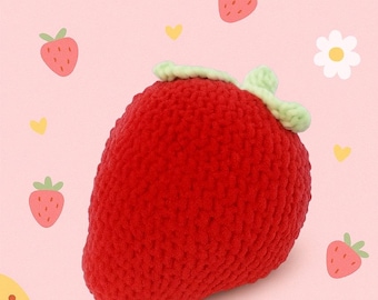 Peut inclure: Une grosse fraise rouge au crochet faite à la main avec des feuilles vertes. La fraise est le point central, sur un fond rose avec des illustrations de fraises et de fleurs. Un design charmant et fantaisiste.