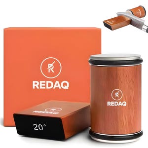 May include: An orange box and a cylindrical knife sharpener with a wooden finish. The box and sharpener have the brand name "REDAQ" and logo printed on them. A smaller, angled sharpener with "20°" printed on it is also visible.