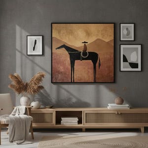May include: A living room scene featuring a large framed artwork of a black horse with a rider, set against a warm-toned landscape. The room includes a wooden cabinet, framed abstract art, a beige chair, and decorative elements.